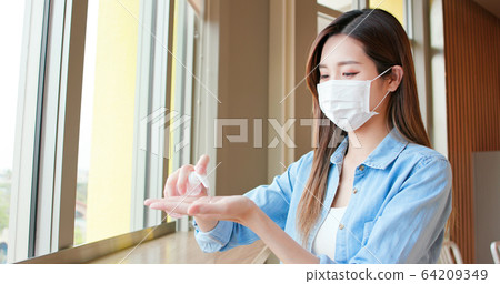 asian woman use sanitizer gel asian woman use sanitizer gel 64209349