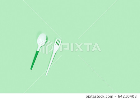 Plastic spoons on blue background. Plastic spoons on blue background. 64210408