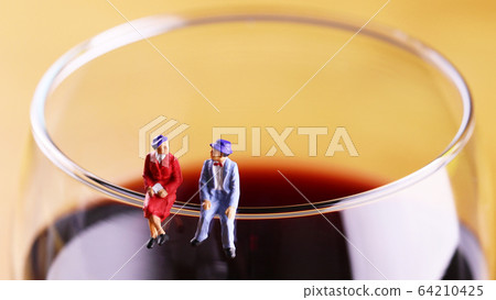 Senior couple sitting with glasses of red wine Senior couple sitting with glasses of red wine 64210425