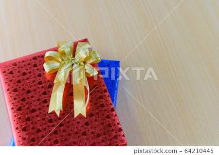 Top view on gift box with bow on wooden background 64210445