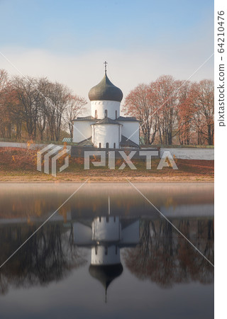 Spaso-Preobrazhensky Cathedral of the Mirozhsky monastery reflected in the water of the Great river. 64210476