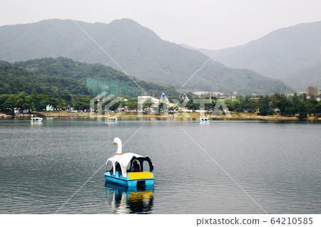 Duck boat on lake with mountain at Uirimji Reservoir in Jecheon, Korea Duck boat on lake with mountain at Uirimji Reservoir in Jecheon, Korea 64210585