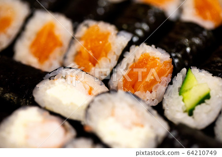 Thin rolls with salmon,cucumber,shrimp close up Thin rolls with salmon,cucumber,shrimp close up 64210749