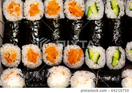 Thin rolls with salmon,cucumber,shrimp close up Thin rolls with salmon,cucumber,shrimp close up 64210750