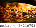 Pizza baked in an electric oven close-up 64210753