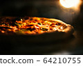 Pizza baked in an electric oven close-up 64210755