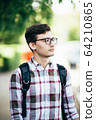 handsome young man smiling outdoors 64210865