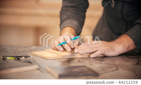 Carpentry working - making marks on the wood 64212259