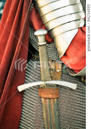 Medieval knight. Close-up of sword and armor 64214893