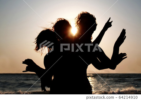 Group of young women having fun on the beach at sunset. Girls si 64214910