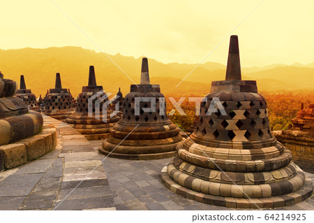 Borobudur Temple at sunset. Ancient stupas of Borobudur Temple. Borobudur Temple at sunset. Ancient stupas of Borobudur Temple. 64214925