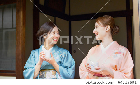 Foreign and Japanese women drinking tea in kimono Foreign and Japanese women drinking tea in kimono 64215691
