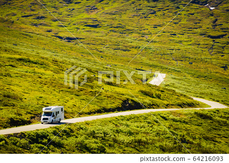 Camper car on road in norwegian mountains Camper car on road in norwegian mountains 64216093