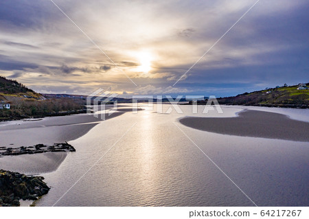 Sunset close to the bridge to Lettermacaward in County Donegal - Ireland. 64217267