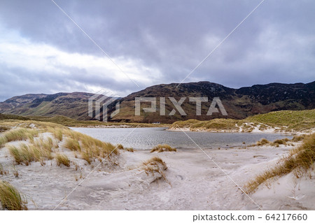 The dunes at Maghera Beach near Ardara, County Donegal - Ireland. The dunes at Maghera Beach near Ardara, County Donegal - Ireland. 64217660
