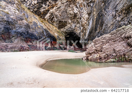 The beach and caves at Maghera Beach near Ardara, County Donegal - Ireland. The beach and caves at Maghera Beach near Ardara, County Donegal - Ireland. 64217718