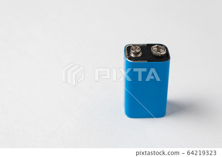 Blue PP3 battery accumulator on white background. 64219323
