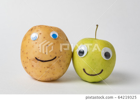 Raw potato and Apple with Googly eyes and drawn Raw potato and Apple with Googly eyes and drawn 64219325