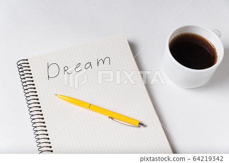 Notepad with the words Dream on white background. Notepad with the words Dream on white background. 64219342