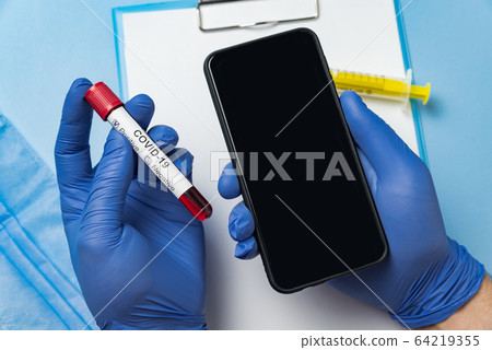 Hands with medical gloves holding test tube with Hands with medical gloves holding test tube with 64219355