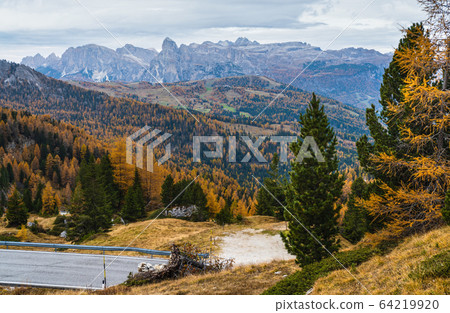 Overcast morning autumn alpine Dolomites mountain scene. Peaceful Valparola Path view, Belluno, Italy. Overcast morning autumn alpine Dolomites mountain scene. Peaceful Valparola Path view, Belluno, Italy. 64219920