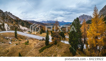 Overcast morning autumn alpine Dolomites mountain scene. Peaceful Valparola Path view, Belluno, Italy. Overcast morning autumn alpine Dolomites mountain scene. Peaceful Valparola Path view, Belluno, Italy. 64219922