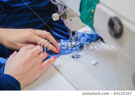 Professional fashion designer working at sewing studio - close up view 64220167