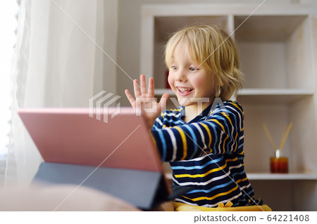 Little boy is meeting and talking in video chat Little boy is meeting and talking in video chat 64221408