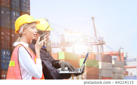 Businesswoman and engineering hold computer or Businesswoman and engineering hold computer or 64224115