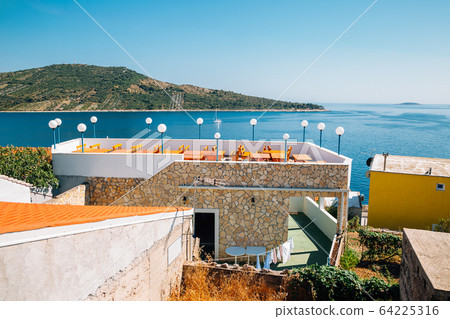 Adriatic sea and village at summer in Primosten, Croatia Adriatic sea and village at summer in Primosten, Croatia 64225316
