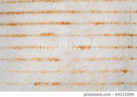 Background of tortilla dough made on the grill. Background of tortilla dough made on the grill. 64231099