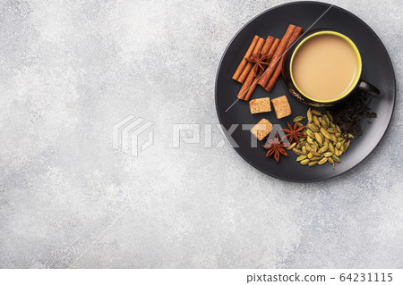 Indian drink masala tea with milk and spices. 64231115