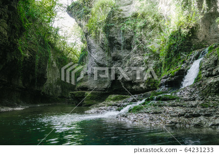 mountain river and stream among high stone cliffs with green plants in Martville Canyon in Georgia mountain river and stream among high stone cliffs with green plants in Martville Canyon in Georgia 64231233