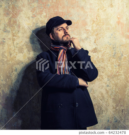 man with grungy blond hair dressed warmly  64232478