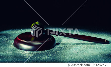 Judge's gavel lies on a stone table. Judge's gavel lies on a stone table. 64232479