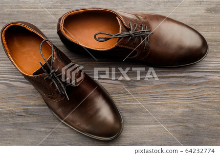 Fashionable men's classic brown shoes on a wooden Fashionable men's classic brown shoes on a wooden 64232774