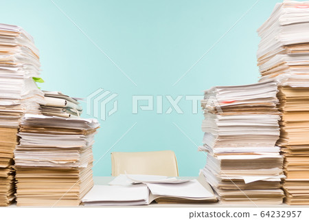 Stack of paper on desktop in office. 64232957