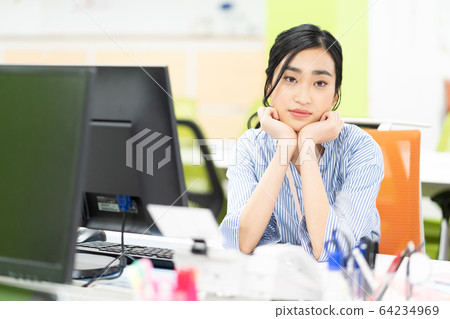 Young female employee depressed in office Young female employee depressed in office 64234969