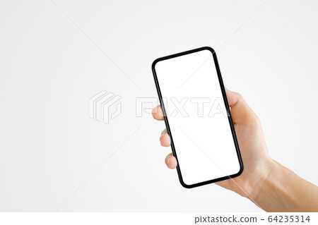 Hand holding old black smartphone with gray background. 64235314