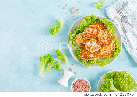 Chicken cutlets with fresh lettuce salad on plate Chicken cutlets with fresh lettuce salad on plate 64235879