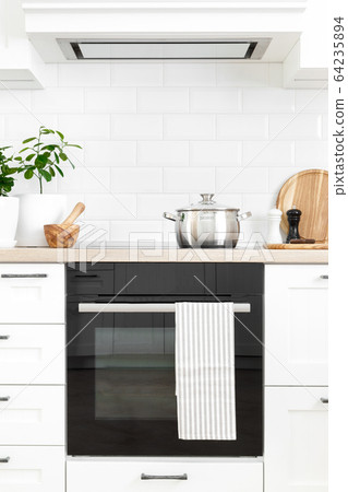 White modern kitchen interior with wooden worktop 64235894