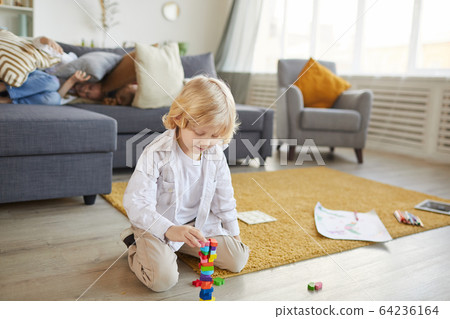 Boy playing with toys at home 64236164