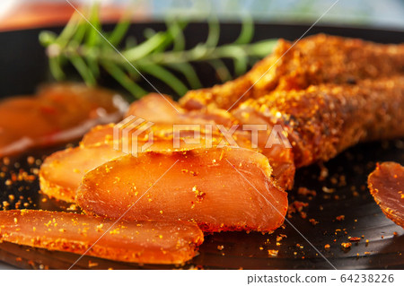 Seasoned chicken with hot sauce and a sprig of rosemary Seasoned chicken with hot sauce and a sprig of rosemary 64238226