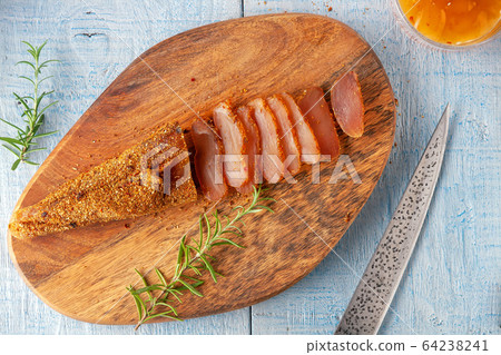 Seasoned chicken with hot sauce and a sprig of rosemary Seasoned chicken with hot sauce and a sprig of rosemary 64238241