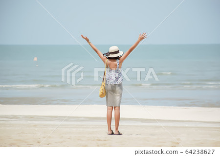 The image behind Asian women raise their arms and wear a hat background sea The image behind Asian women raise their arms and wear a hat background sea 64238627