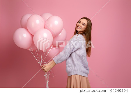birthday girl posing with balloons birthday girl posing with balloons 64240394