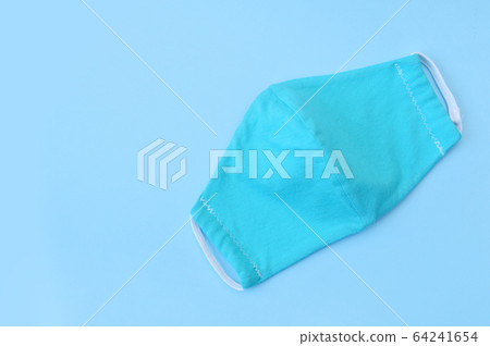 Protective turquoise face virus mask nurse on blue Protective turquoise face virus mask nurse on blue 64241654