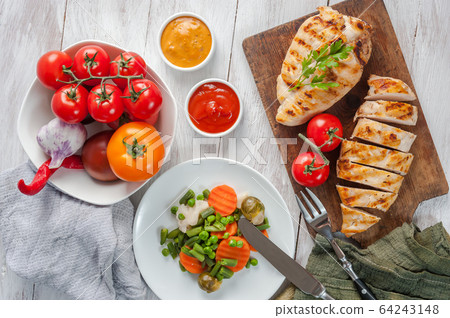 Chicken fried fillet and boiled vegetables 64243148