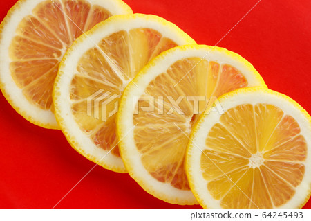Sliced bright juicy lemon on a red background. Sliced bright juicy lemon on a red background. 64245493