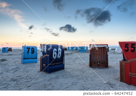 Roofed Wicker Beach Chairs at the Beach of Neuharlingersiel at Dusk, East Frisia, Germany Roofed Wicker Beach Chairs at the Beach of Neuharlingersiel at Dusk, East Frisia, Germany 64247452